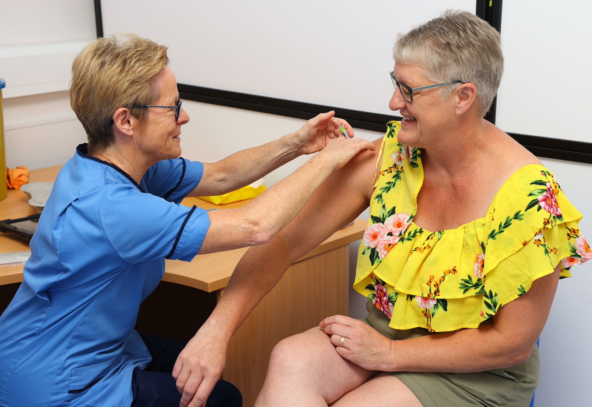 Nurse Administering A COVID Vaccine To An Adult