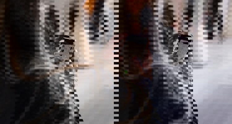 a woman types a number into her phone