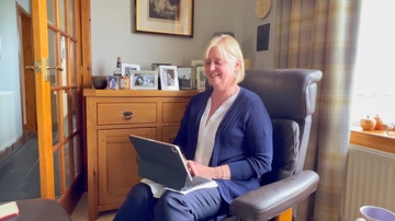patient in chair using laptop