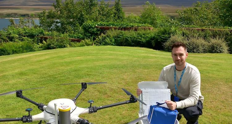 drone and operator in field outdoors