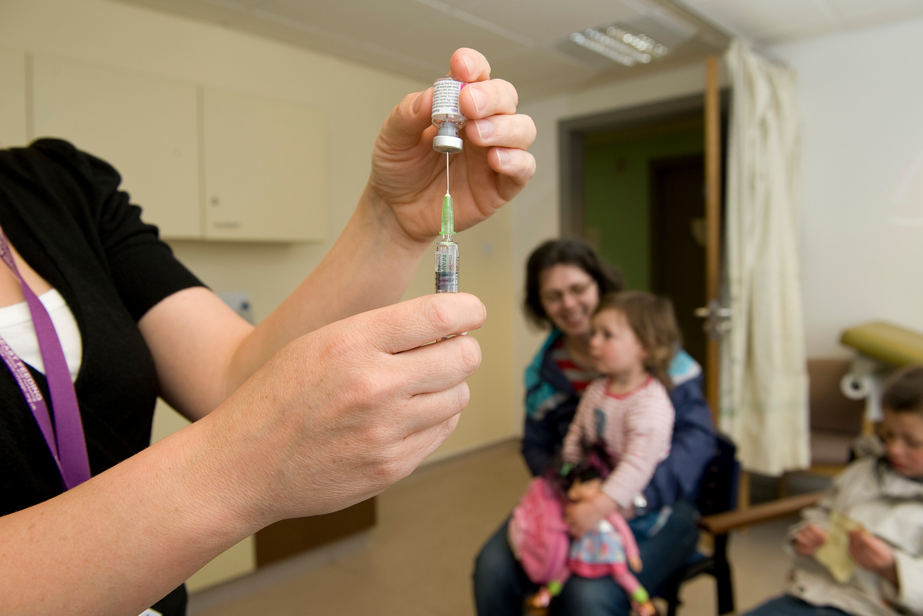 mother and children about to receive vaccination injection