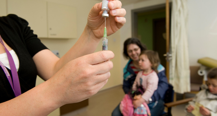 mother and children about to receive vaccination injection