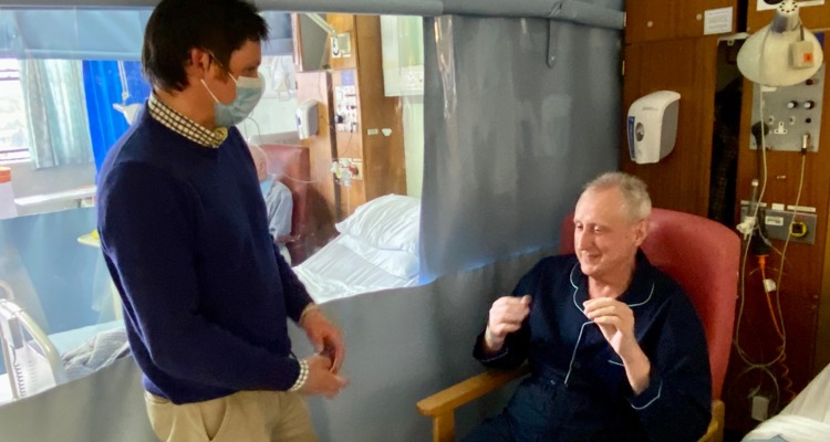 masked doctor talking with patient