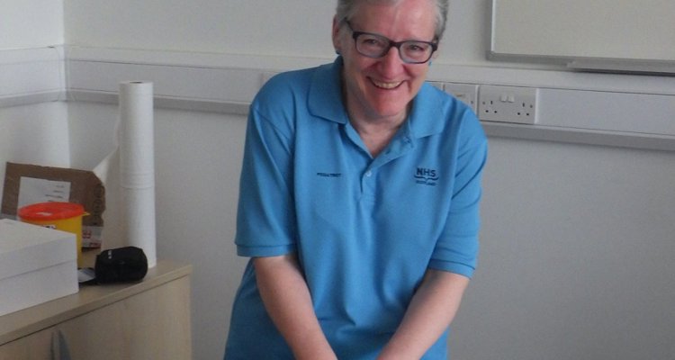 Sandra Jones cutting her retirement cake
