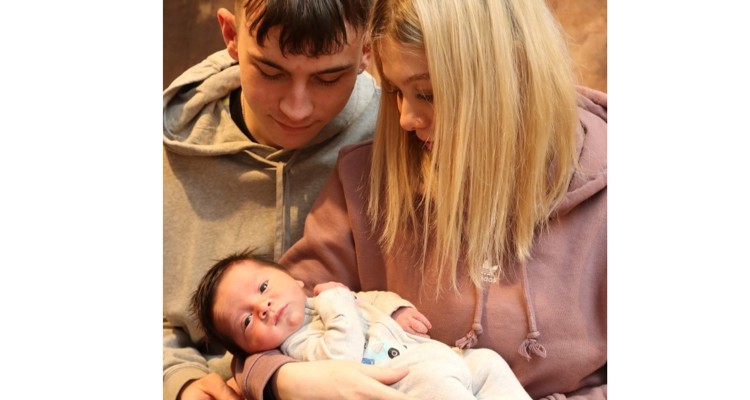 two young parents with their baby